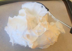 Beaten egg whites on baking sheet for pavlova
