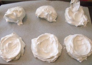 Pavlova nests on baking tray before cooking