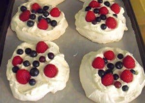 Mini pavlovas decorated with cream and berries
