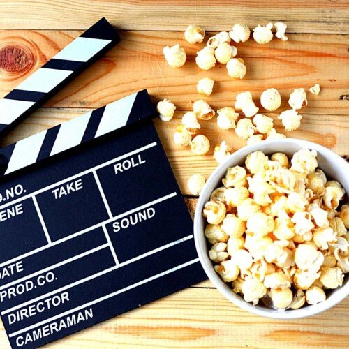 A bowl of popcorn and a movie clapboard | Irish American Mom A movie clap board beside a bowl of popcorn
