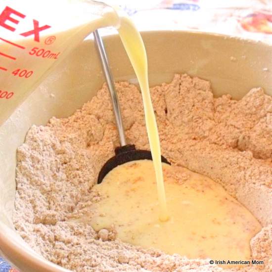 Adding liquid ingredients to dry for Irish brown soda bread | Irish American Mom Adding liquid ingredients to dry for Irish brown soda bread