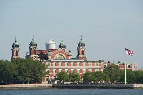 The buildings on Ellis Island with an American flag