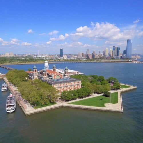 View of an island with buildings and a city skyline behind