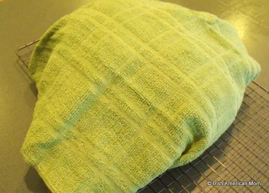 Freshly baked Irish brown bread wrapped in a tea towel or cloth to help soften the crust | Irish American Mom Freshly baked Irish brown bread wrapped in a tea towel or cloth to help soften the crust