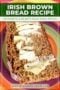 Slice of Irish brown soda bread topped with melting butter on a colorful plate, with Irish-themed recipe text above.