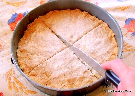Marking a cross on brown bread dough before baking to let the faeries out | Irish American Mom Marking a cross on brown bread dough before baking to let the faeries out