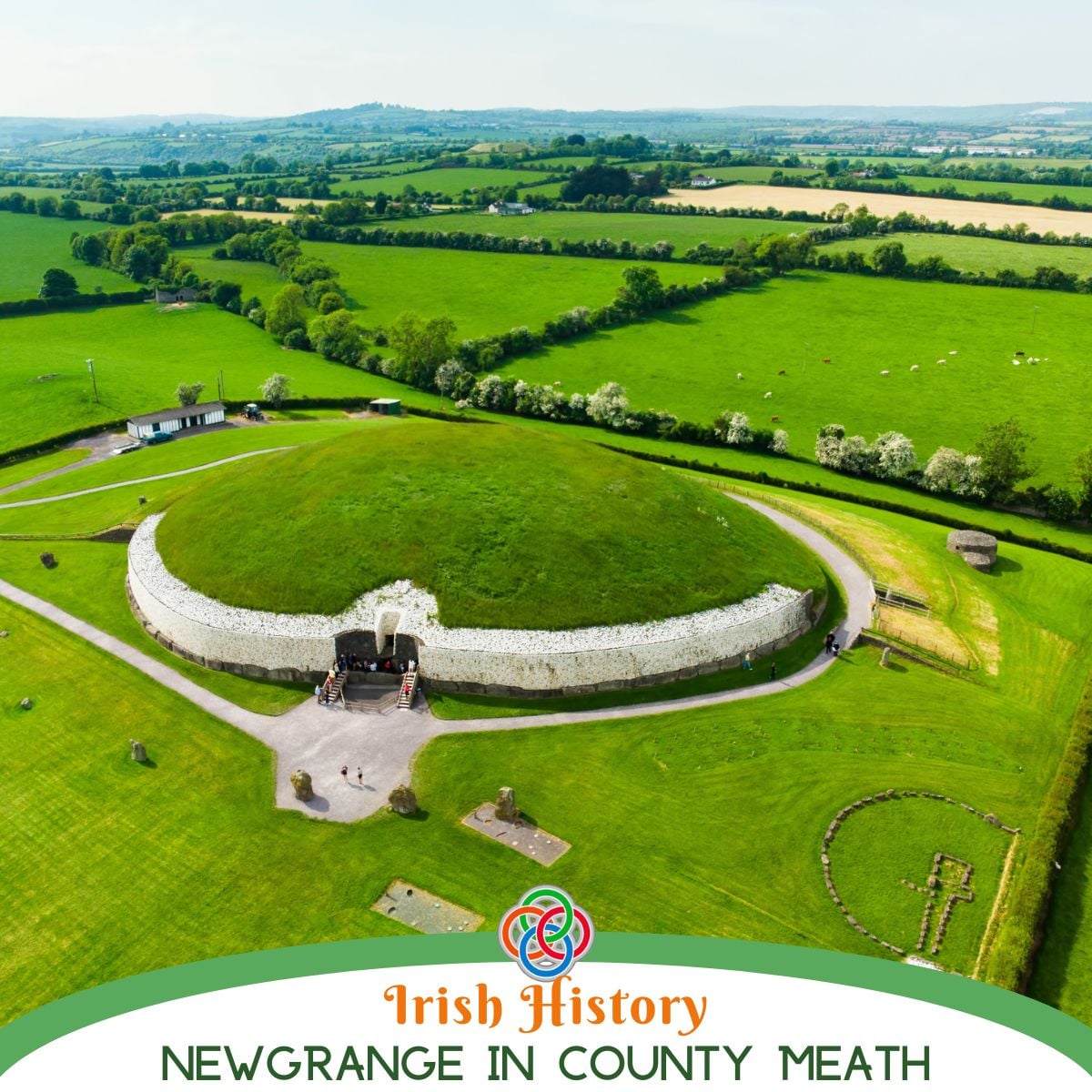 Aerial view of Newgrange passage tomb in County Meath, Ireland, showing the grassy circular mound, white quartz façade, entrance passage, and surrounding green Boyne Valley countryside.