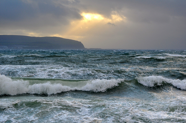 Ocean waves and a distant mountain