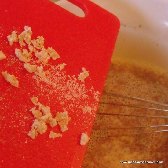 Adding crystallized ginger to milk and eggs.