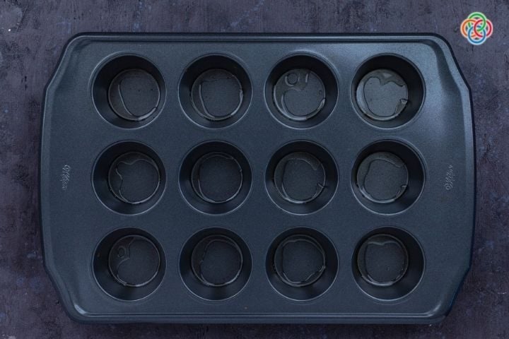 Oiling a muffin pan for yorkshire pudding | Irish American Mom Oil in the compartments of a muffin tray