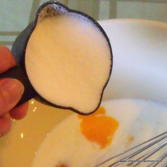Adding sugar to milk and eggs for bread pudding