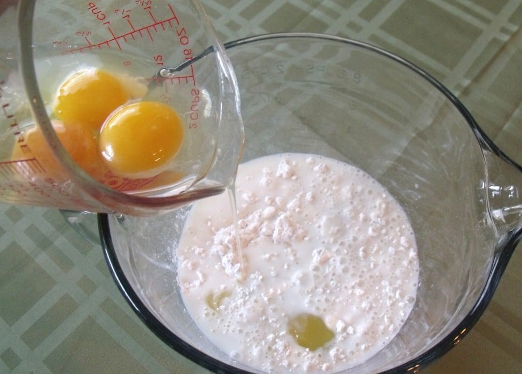 Adding eggs to batter for yorkshire pudding | Irish American Mom Eggs flour and milk in a bowl to make batter for Yorkshire pudding