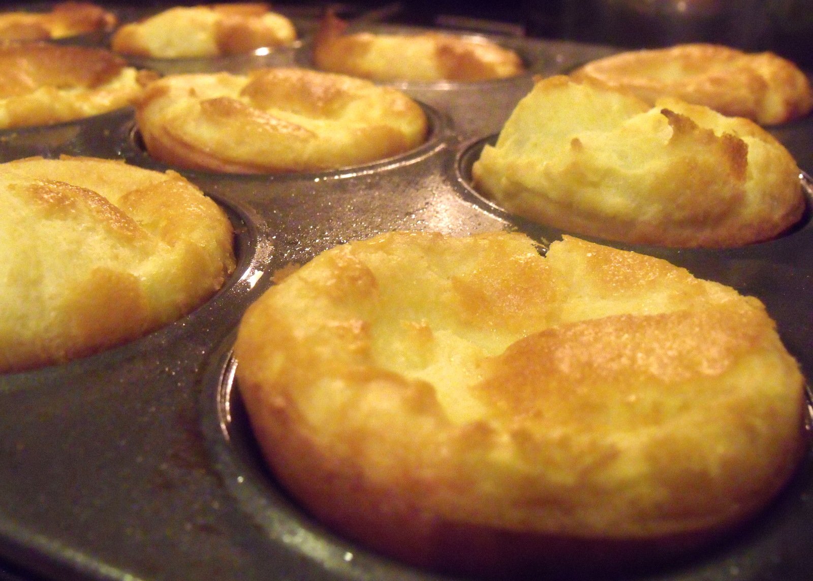 Yorkshire puddings in a muffin pan fresh out of the oven