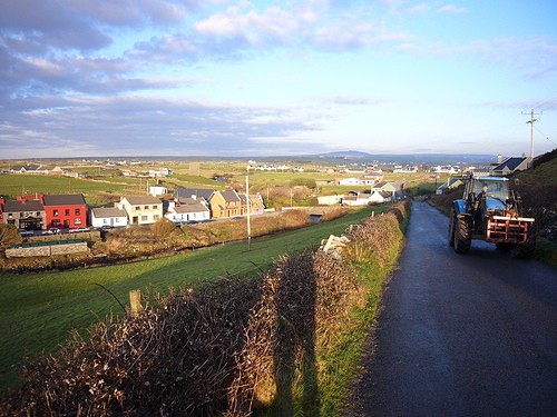 Doolin, Co. Clare | Irish American Mom Tractor on a road near a village