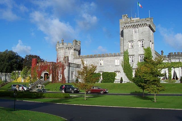 Dromoland Castle | Irish American Mom Stone castle with cars parked in front of it