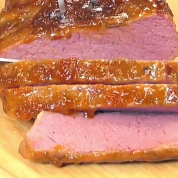 Slices of corned beef with an orange glaze