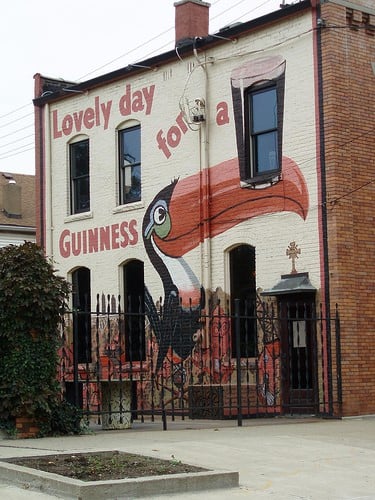 Guinness Toucan Mural Painting of a pelican with a Guinness on its beak plus text
