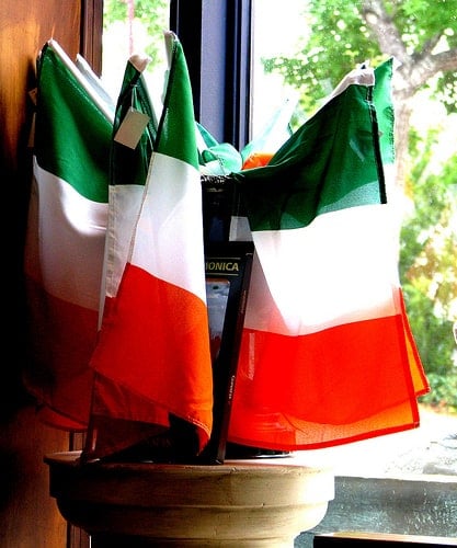 Irish Flags | Irish American Mom A collection of Irish green, white and orange flags in a container on a window sill