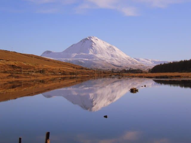Mount Errigal In The Snow | Irish American Mom A body of water with a mountain in the background