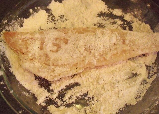 Dredging cod in seasoned flour | Irish American Mom Dredging cod in flour for making beer battered fish.
