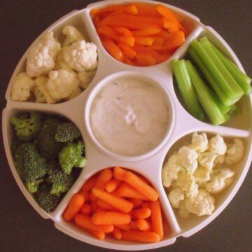 Carrots, broccoli, cauliflower, peppers and celery on a veggie tray with ranch dip