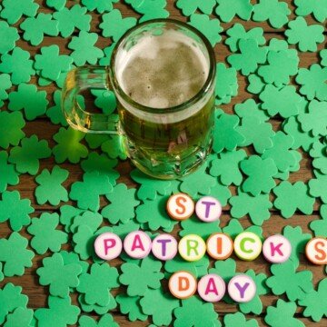 A tankard of beer standing in shamrocks beside text buttons