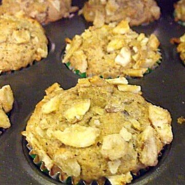 Muffins in a baking pan with a topping of dried banana chips