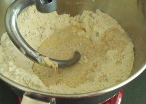 Adding yeast and milk to make dough for hot cross buns