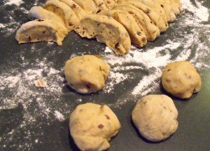 divided dough to roll to form balls for hot cross buns