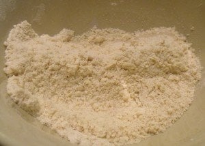 rubbing butter into flour to make pastry for hot cross buns
