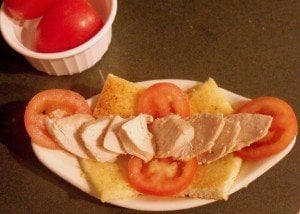 Lining cooked turkey on an open face bread sandwich for a Kentucky Hot Brown Sandwich