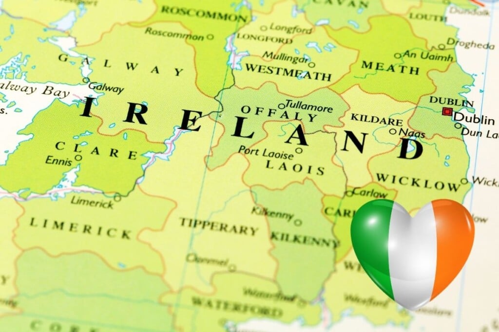 Map of Ireland with an Irish flag shaped like a heart | Irish American Mom Text over a green map with a striped heart
