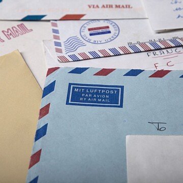 A collection of airmail envelopes scattered over a flat surface.