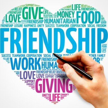 Text shaped as a heart and a hand holding a pen to point to a word