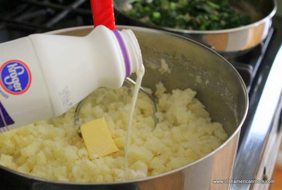 Adding butter and half and half to mashed potato | Irish American Mom Adding butter and half and half to mashed potato