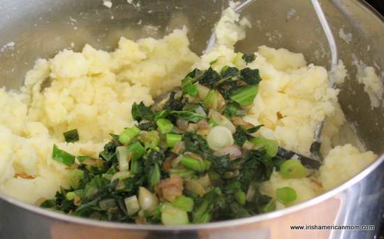 Adding kale to mashed potato for colcannon | Irish American Mom Adding kale to mashed potato for colcannon