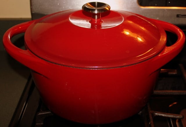 Covered Soup Pot | Irish American Mom A red dutch oven on a stove top cooking carrot and coriander soup