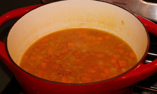Carrot Soup After Simmering | Irish American Mom A pot of carrot and coriander soup in a pot before blending