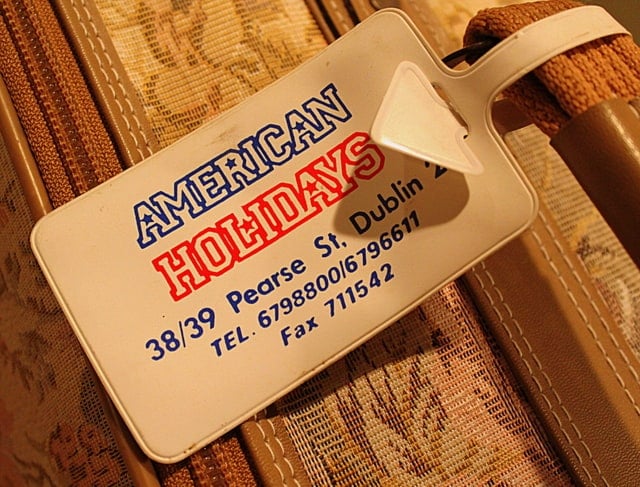 Luggage Tag | Irish American Mom American Holidays Pearse Street Dublin luggage tag on a brocade suitcase from the 1980${2}s