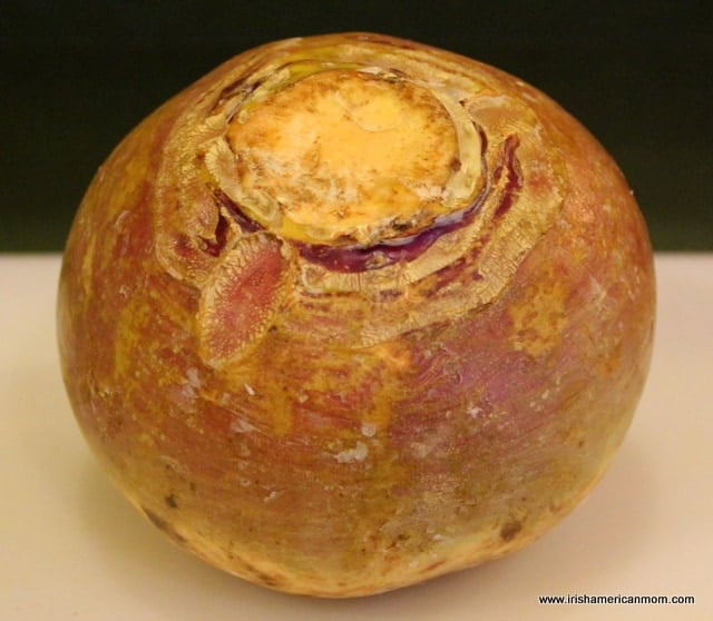 Rutabaga Unpeeled Before Cooking | Irish American Mom A waxed purple and yellow rutabaga