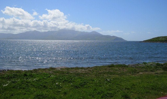 A large body of water with a mountain in the background