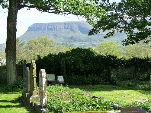 Ben Bulben from Drumcliffe | Irish American Mom Graveyard with a tree at the foot of a mountain