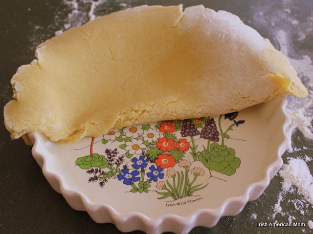 Pastry In Tart Pan Laying a layer of pastry over a pie dish for almond berry tart crust