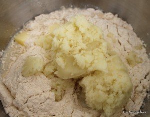 Mashed potato and flour in a mixer for potato bread