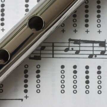 A portion of a tin whistle over a musical score