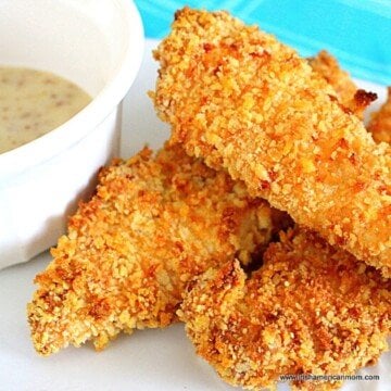 Breaded chicken tenders beside a bowl of dipping sauce