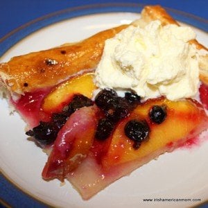 serving a slice of fruit galette with freshly whipped cream