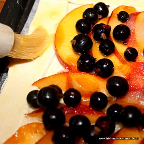 Applying egg wash to pastry for a galette