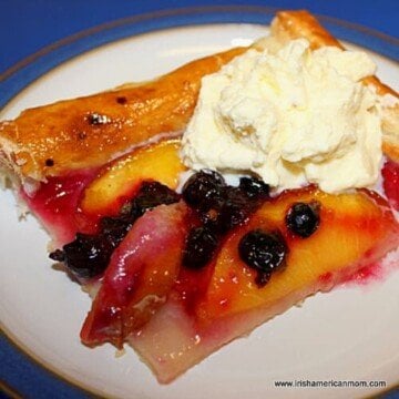 Slice of fruit galette served with cream