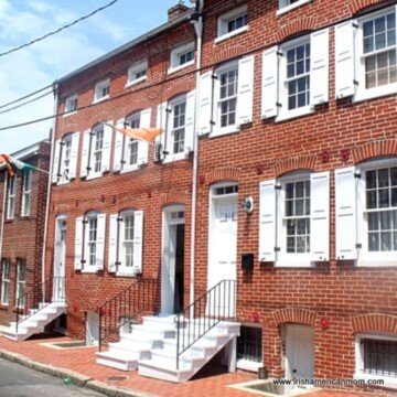 Red brick row houses with an Irish flag outside